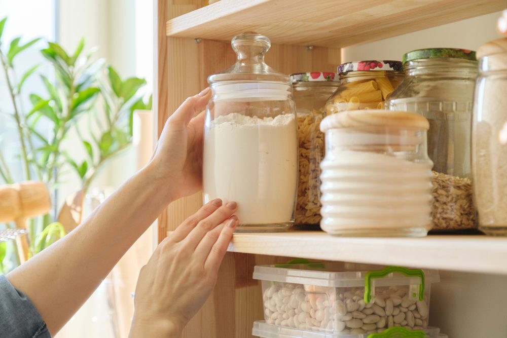 Woman reaching for jar from the pantry,