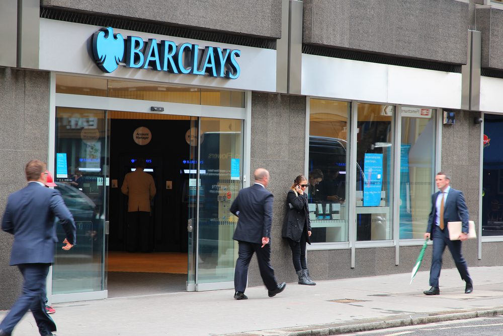 People walking in front of Barclays.