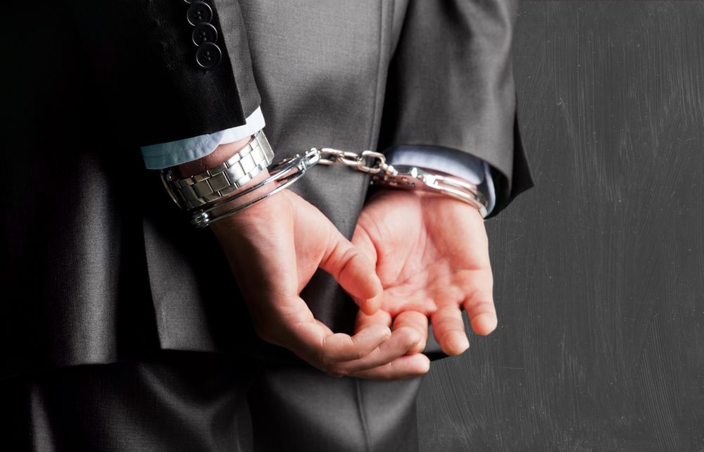 Businessman in handcuffs.