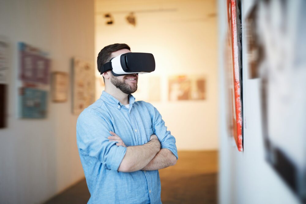Waist up portrait of contemporary man wearing VR headset in art gallery, copy space